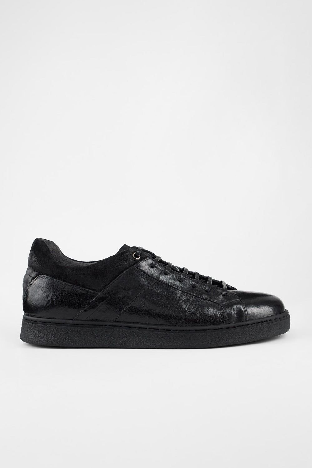 CREED jet-black distressed sneakers.