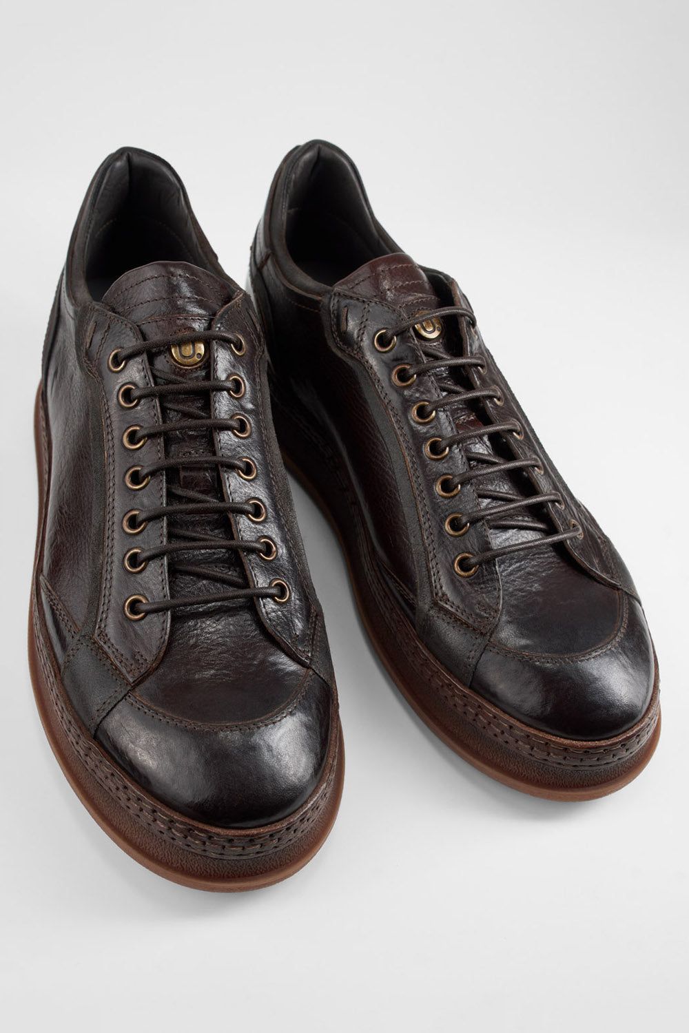 COLE dark-cocoa welted distressed sneakers.
